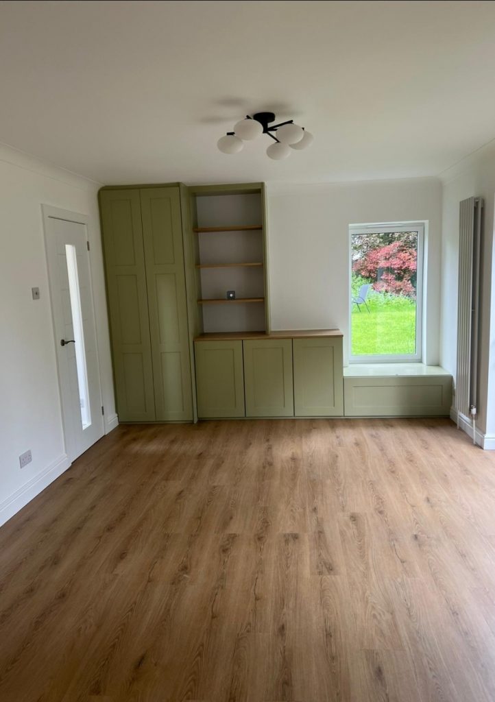 Bespoke built-in shaker cabinetry with shelving and window seat
