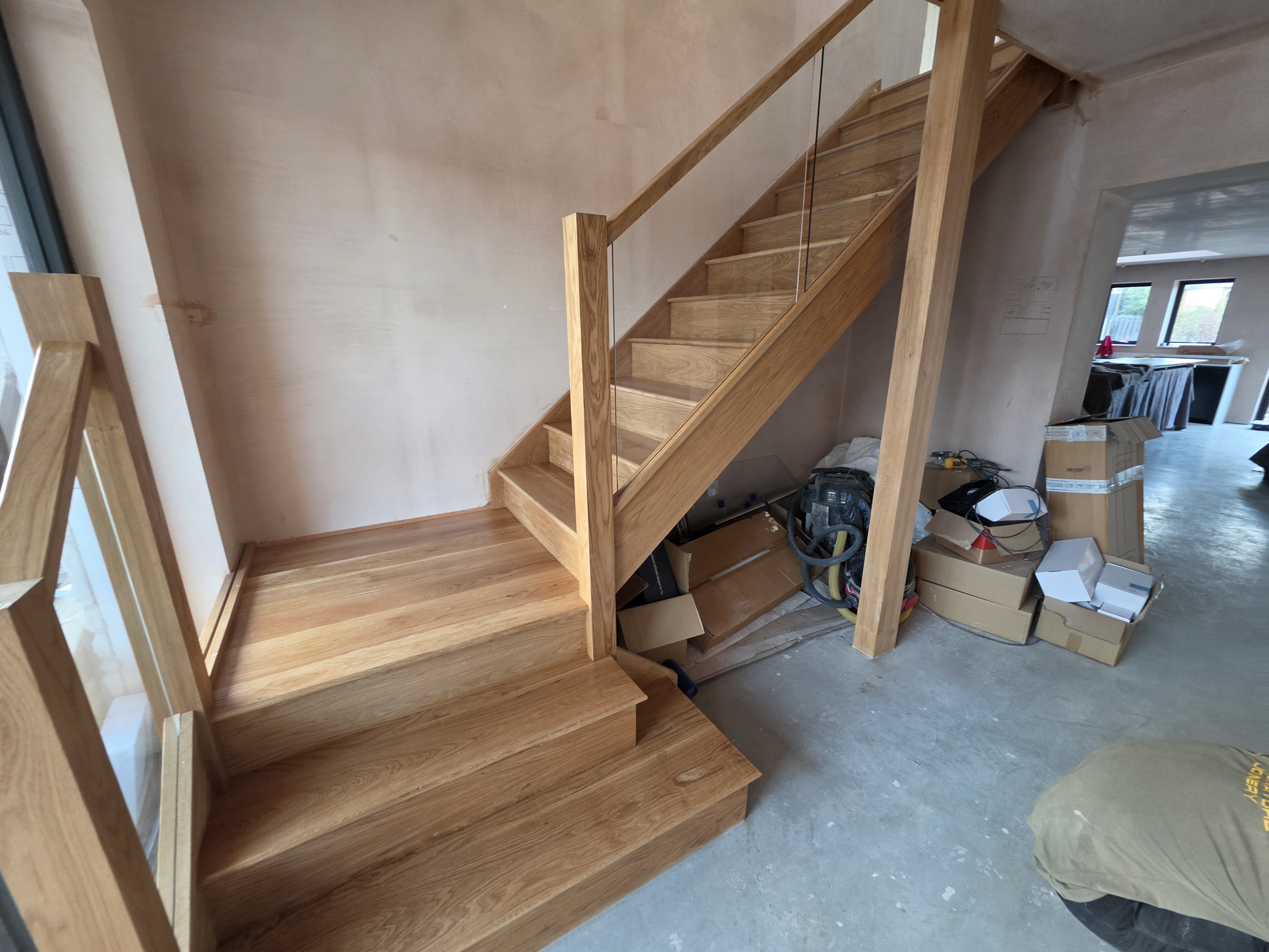 Bespoke oak staircase with glass balustrade installed in Leeds
