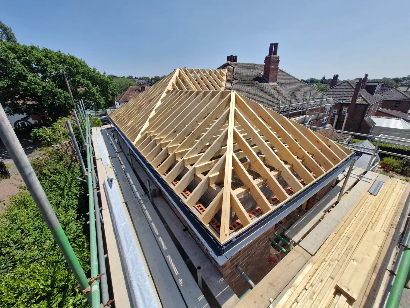 Timber roof structure under construction.